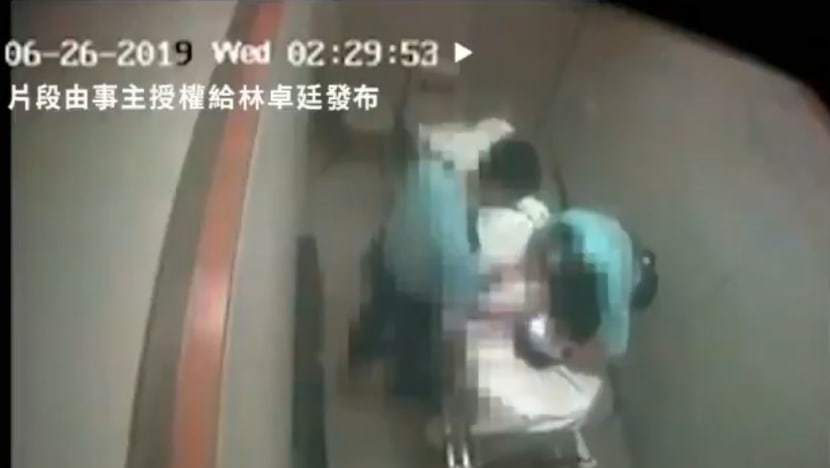 2 Hong Kong police officers arrested after video of man assaulted in hospital goes viral
