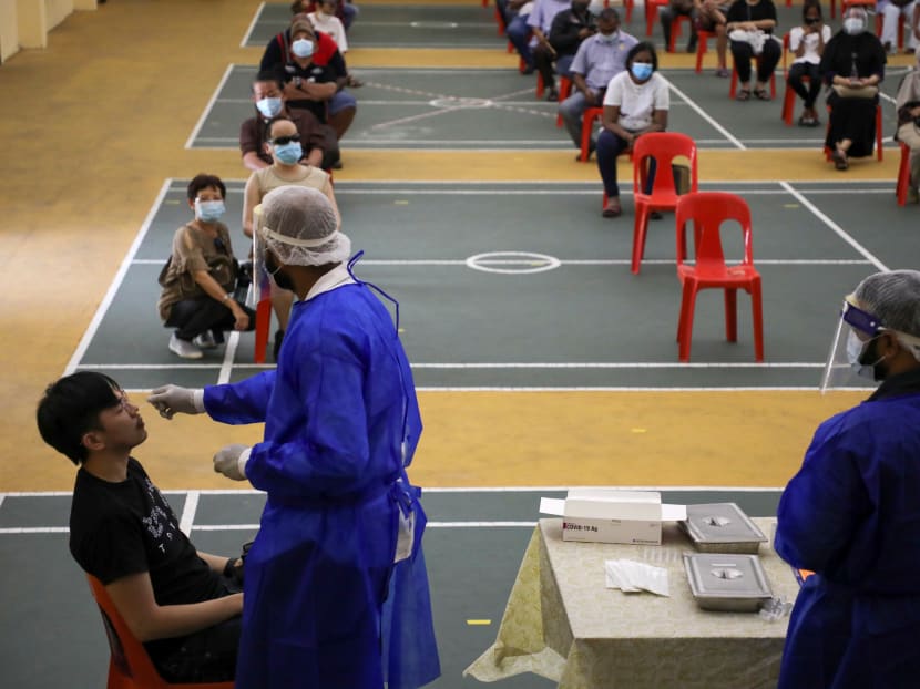 Medical worker collects a swab sample from a man to be tested for the coronavirus disease in Petaling Jaya, Malaysia on Monday, Jan 18, 2021.