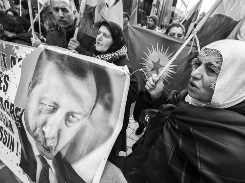Kurds holding a picture of Turkish President Recep Tayyip Erdogan during a protest. Turkey’s long-standing problems with its restive Kurdish minority have returned with a vengeance as Mr Erdogan has resorted to strong-arming the Kurds into submission. Photo: Reuters