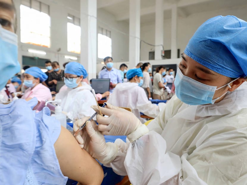 A health worker administers the Sinovac vaccine to a resident in China's southern Guangxi region on June 3, 2021. China has since fully vaccinated more than one billion people — more than 78 per cent of the population — as of mid-September, according to the National Health Commission.