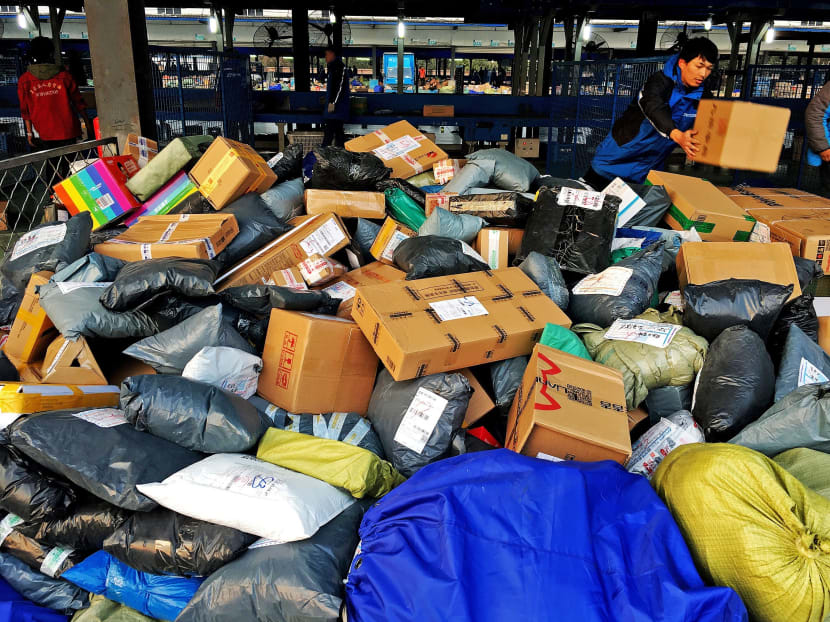An employee sorting parcels at a ZTO Express logistic centre during the Alibaba 11.11 global shopping festival, in Beijing last Friday. Employees of waste-disposal and recycling firms say that the spending orgy on China’s Singles Day could choke landfills and take a huge toll on the environment. Photo: REUTERS