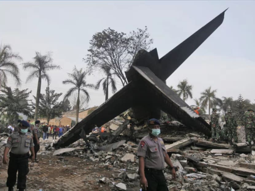 Rescuers search for victims at the site where an Indonesian air force transport plane crashed in Medan, North Sumatra, Indonesia, Wednesday, July 1, 2015. Photo: AP