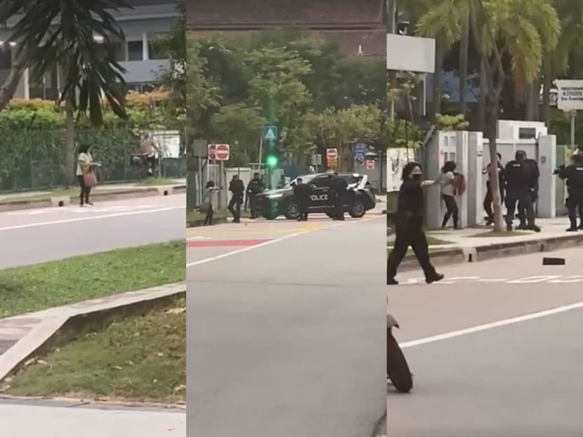 Videos posted on social media show a woman, dressed in a green top, screaming and shouting as she paces about on the road, stopping the flow of traffic outside St Hilda’s Secondary School.