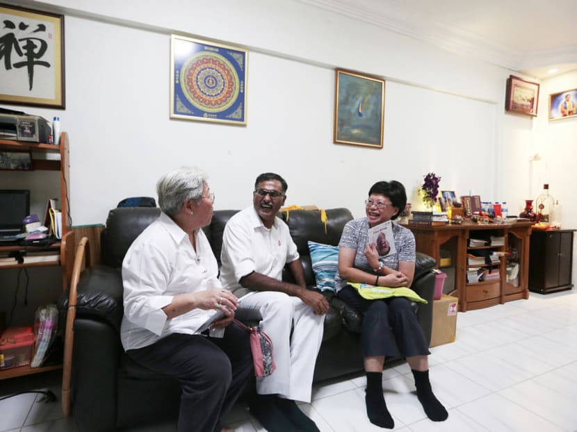 PAP candidate for Bukit Batok SMC Murali Pillai (centre) and a party volunteer (left) meeting a Bukit Batok resident during a house visit on March 21, 2016. Photo: Jason Quah