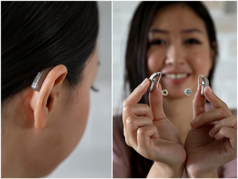 Ms Daphne Neo pictured with the hearing aids she wears.