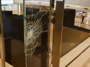 A bullet mark is seen on a glass at the luxury Siam Paragon shopping mall after Thai police arrested a teenage gunman who is suspected of killing foreigners and wounding other people in a shooting, in Bangkok, Thailand on Oct 4, 2023. 

