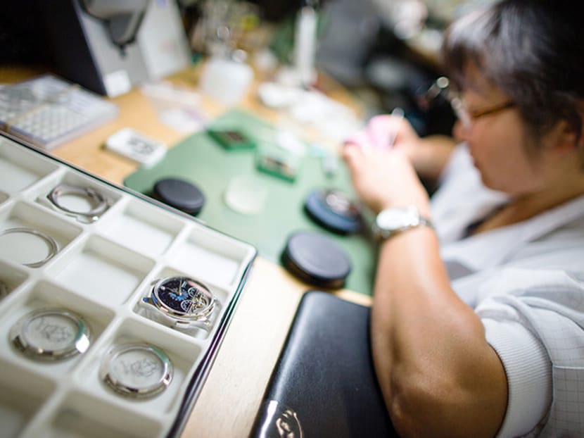 A technician works on the mechanism of a handmade wristwatch at the Montblanc luxury watch factory in Le Locle, Switzerland. Photo: Bloomberg