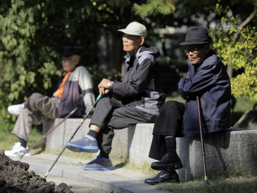 Elderly men sit on benches at Tapgol Park in the Jongro-gu area of Seoul, South Korea. Photo: Bloomberg