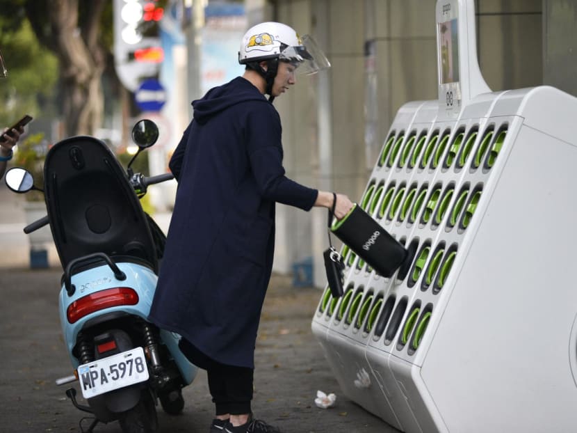 File photo of a man swapping batteries at a Gogoro GoStation unit in Taipei on March 26, 2018.