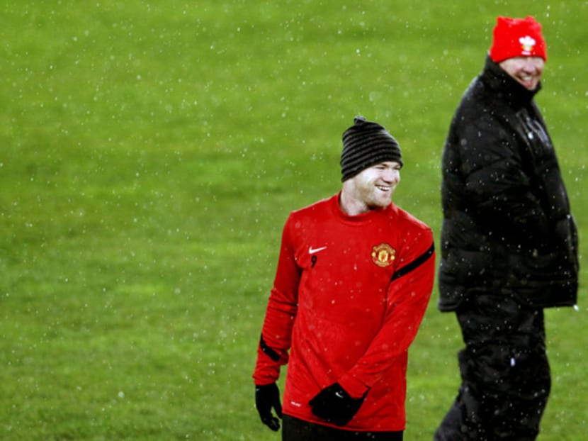 The fallout occurred when Ferguson (in black) left in 2013 and claimed Rooney wanted to leave United. Photo: Reuters