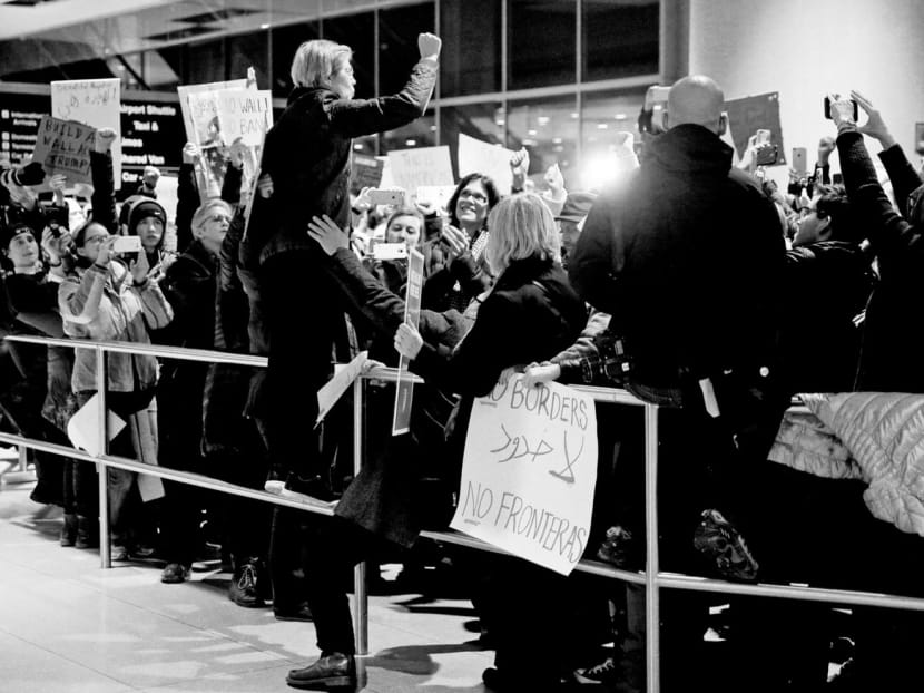 US Senator Elizabeth Warren addressing demonstrators at Logan Airport in Boston, Massachusetts, during a protest against US President Donald Trump’s executive order on immigration. Some believe the latest series of protests, in which many Democrats have participated, could be the beginning of an all-out Democratic war against Mr Trump. Photo: Reuters