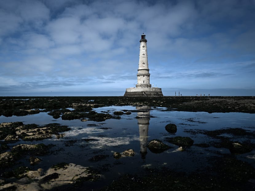 The Cordouan lighthouse is seen at low tide off the coast of Le Verdon-sur-Mer, southwestern France on June 10, 2021.