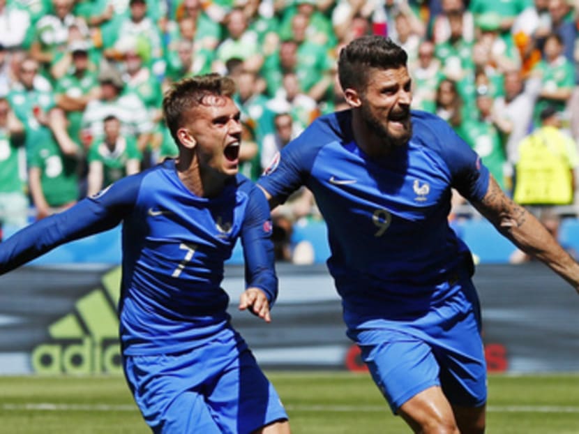 Griezmann (left, with team-mate Olivier Giroud) underlined a superb performance as the main strike threat with two knockout goals in the second half. Photo: Reuters