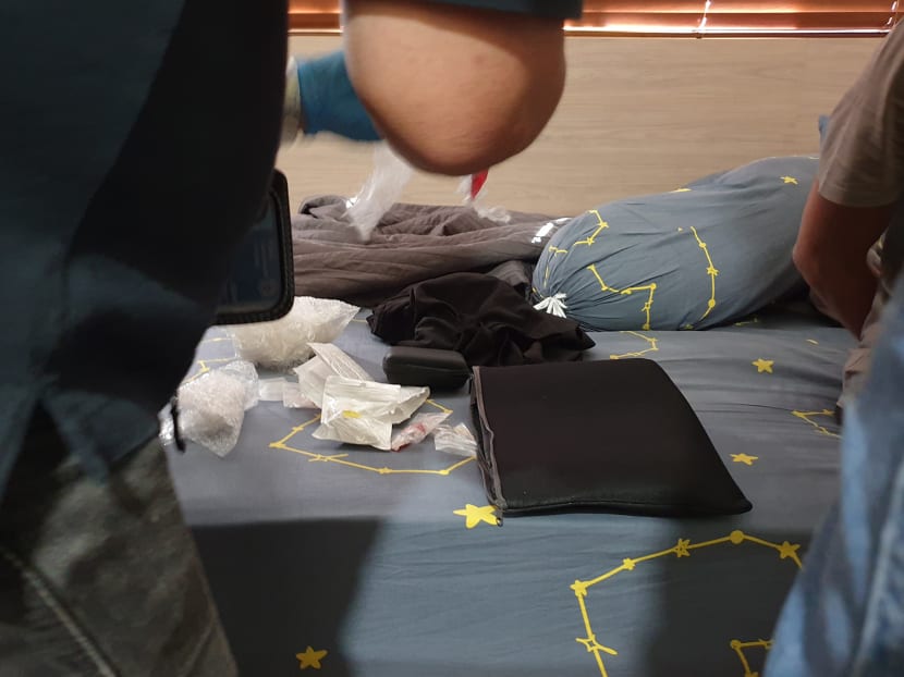 Central Narcotics Bureau officers conducting a thorough search of a drug abuser's bedroom. Central Narcotics Bureau officers conducting a thorough search of a drug abuser's bedroom.
