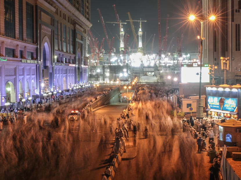 Muslim pilgrims walk towards the Grand Mosque in the holy city of Mecca, Saudi Arabia, marked by towering cranes used in the ongoing expansion aimed to accommodate the growing numbers of annual pilgrims. Photo: AP