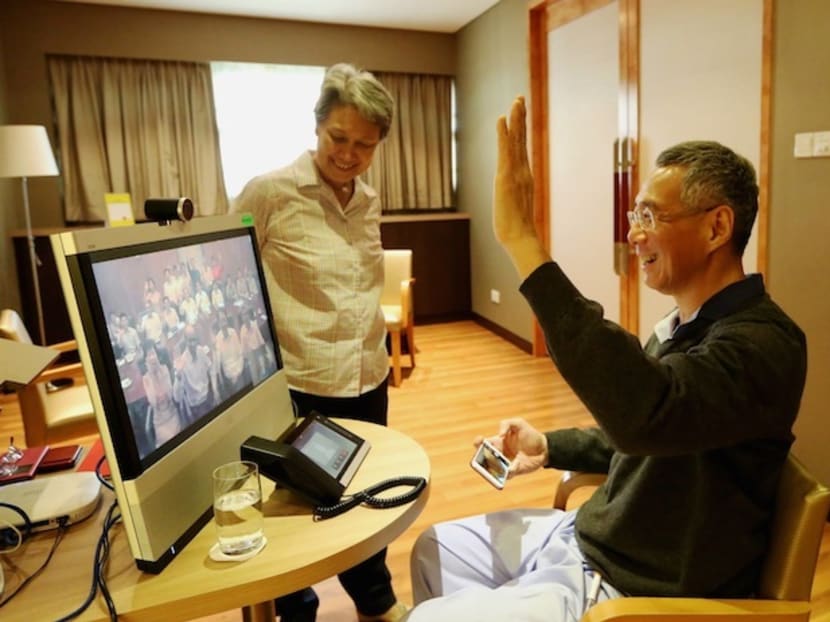Prime Minister Lee Hsien Loong talks to ministers via video conference at his hospital room at the Singapore General Hospital, a day after his prostate cancer surgery, in 2015.