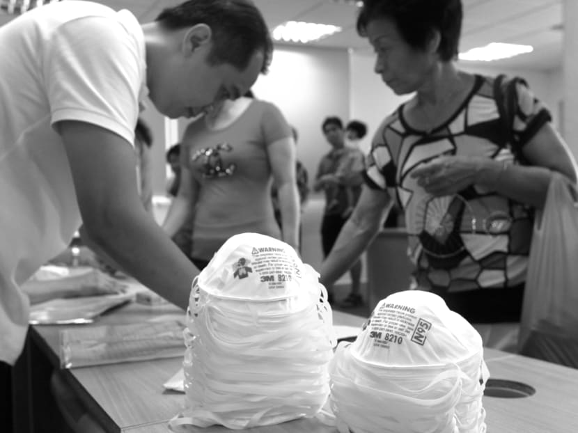 Volunteers handing out haze masks to residents in Ang Mo Kio. It is crucial how we

nurture the sense of looking out for each other in times of crisis. TODAY file photo