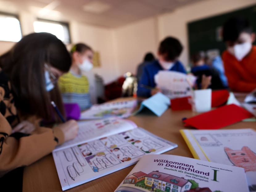 A book called 'Welcome to Germany' is pictured as refugee children, who fled following Russia's invasion of Ukraine, attend a preparation course in a school in Dusseldorf, Germany. 