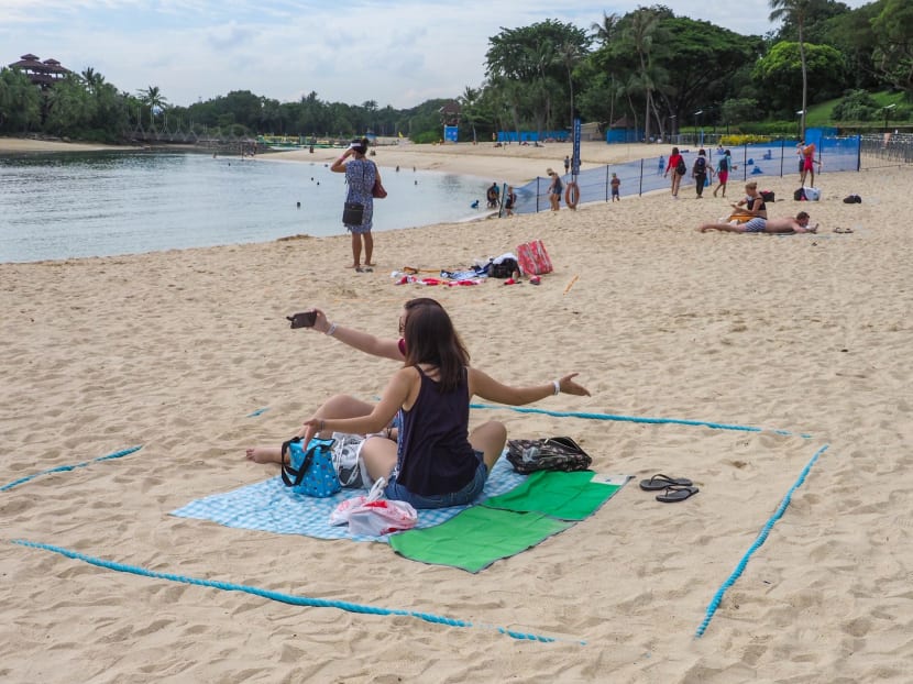 Beachgoers at Sentosa on Oct 18, 2020. Bookings are required to secure entry into the beaches on Sentosa from Oct 17.