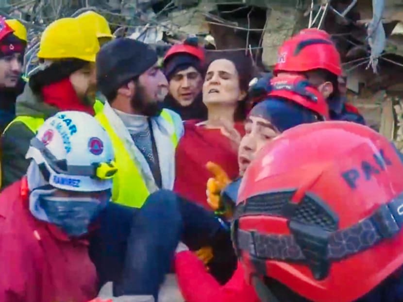 A handout picture released by El Salvador's presidency press office showing members of El Salvador's Urban Search and Rescue Team carrying a woman during rescue operations in Kahramanmaraş, Turkiye, on Feb 12, 2023.