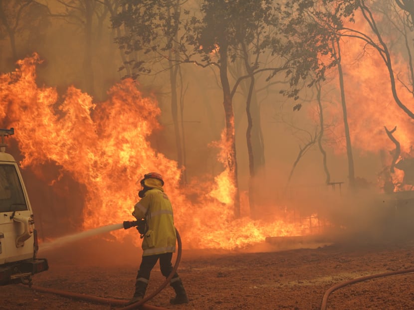 This handout photo taken on February 2, 2021 and released by West Australia's Department of Fire and Emergency Services (DFES) shows a firefighter fighting a fire outside Wooroloo, near Australia's fourth-biggest city Perth. This handout photo taken on February 2, 2021 and released by West Australia's Department of Fire and Emergency Services (DFES) shows a firefighter fighting a fire outside Wooroloo, near Australia's fourth-biggest city Perth.