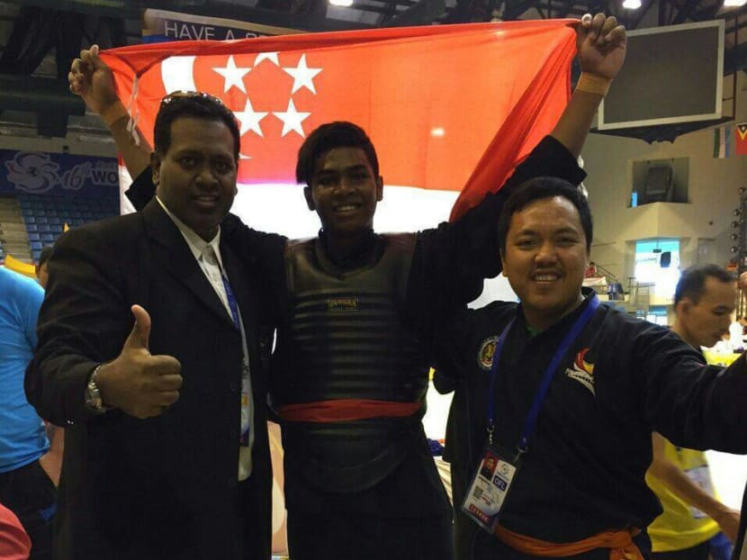 Sheik Farhan (centre) celebrating after winning the gold medal at the Pencak Silat World Championships with his father Sheik Alau'ddin (left) Photo: Lawrence Wong/Facebook