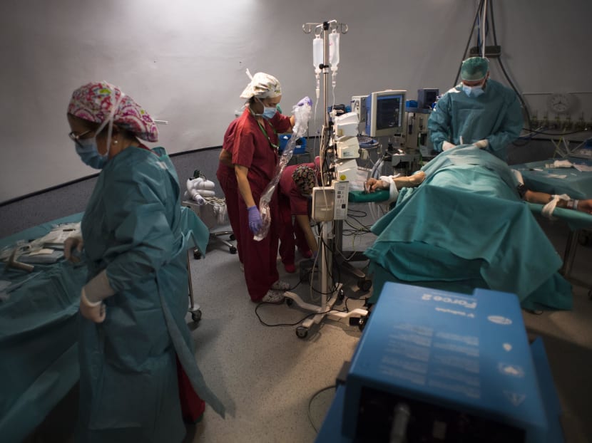 A specialised nurse (centre) and an anesthetist (right) preparing patient Juan Benito Druet before his renal transplantation at La Paz hospital in Madrid on Feb 28, 2017. Photo: AFP