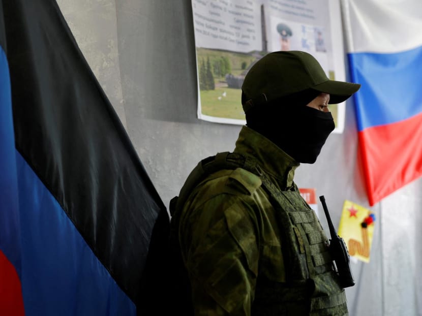 A service member of the self-proclaimed Donetsk People's Republic stands guard at a polling station ahead of the planned referendum on the joining of the Donetsk people's republic to Russia, in Donetsk, Ukraine Sept 22, 2022. A service member of the self-proclaimed Donetsk People's Republic stands guard at a polling station ahead of the planned referendum on the joining of the Donetsk people's republic to Russia, in Donetsk, Ukraine Sept 22, 2022.