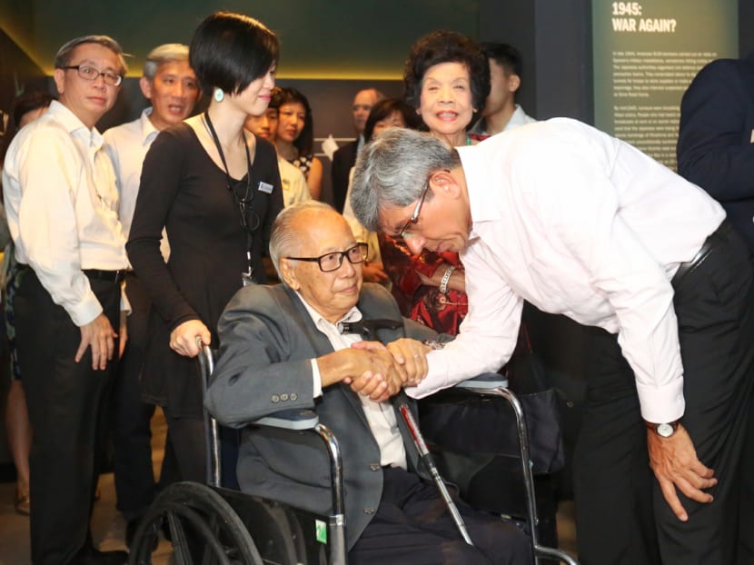 Mr Raymon Huang, 90, war survivor, speaking with Dr Yaacob Ibrahim during the official opening of the exhibition at the Old Ford Factory, Feb 15, 2017. Photo: Nuria Ling/TODAY