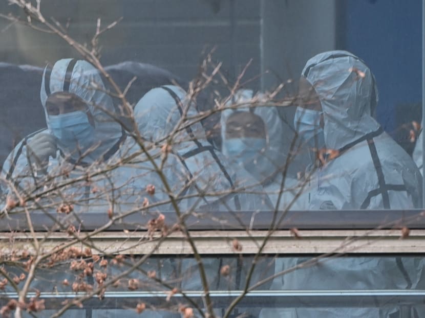 Members of the World Health Organization team investigating the origins of Covid-19, wearing protective gear, are seen during their visit to the Hubei Center for animal disease control and prevention in Wuhan, China's central Hubei province on Feb 2, 2021.
