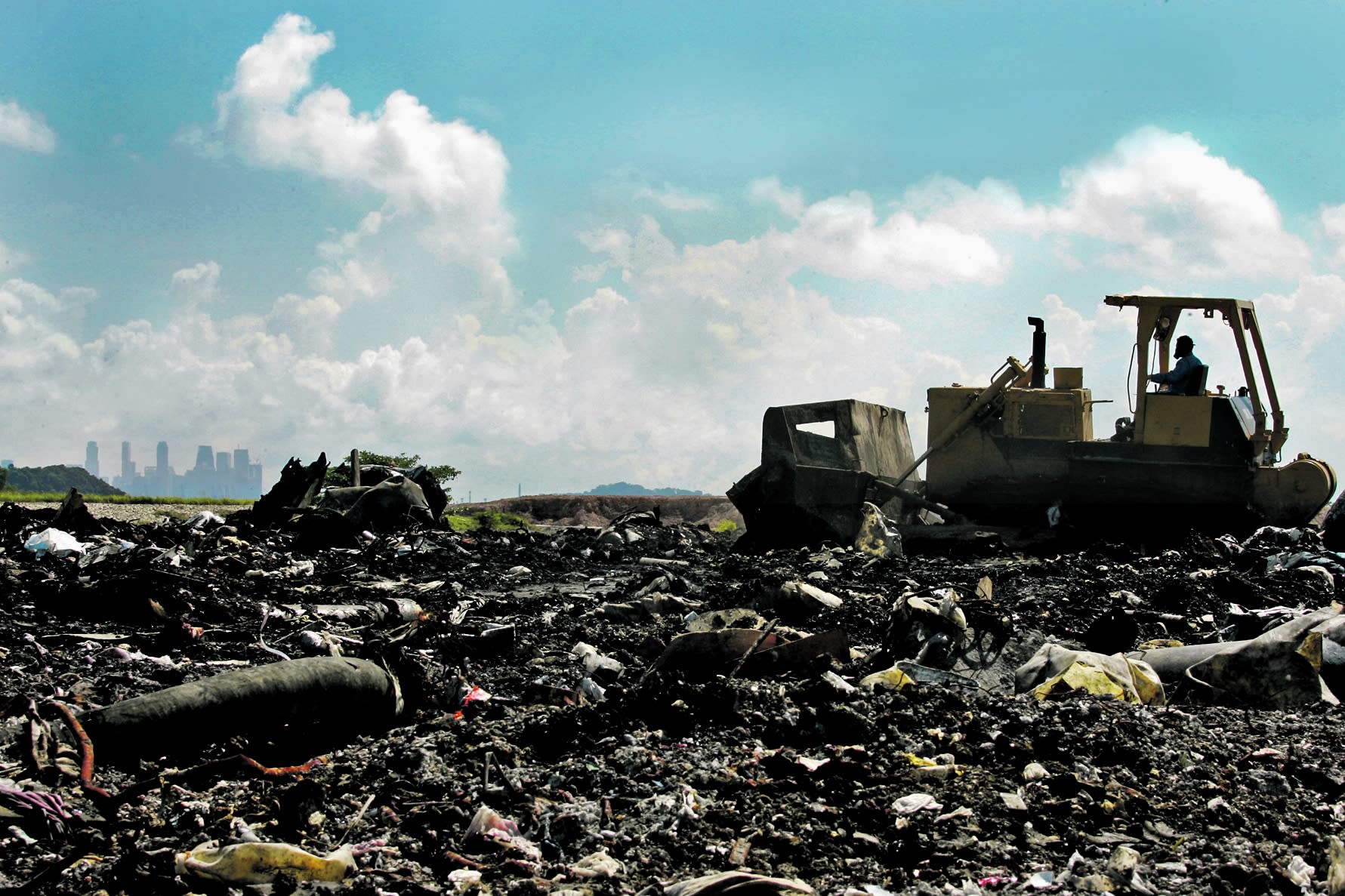 Bulldozers and compactors are used to level and compact the waste at a landfill cell at the Semakau Landfill, which is Singapore's only landfill for waste disposal. 