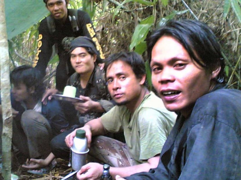 In this undated file photo provided by the Philippine National Police, Al Qaeda-linked Abu Sayyaf leader Isnilon Hapilon (second from right) is seen with other Abu Sayyaf members in their jungle camp on the island of Jolo. Photo: Philippine National Police via AP