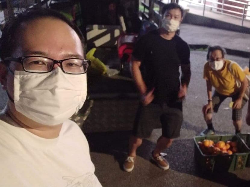 In the first week of September, Mr Daniel Tay (left) and several other freegans — who retrieve unwanted, edible goods to cut waste — collected more than 200 oranges and other fruits that had been used as offerings for the dead.