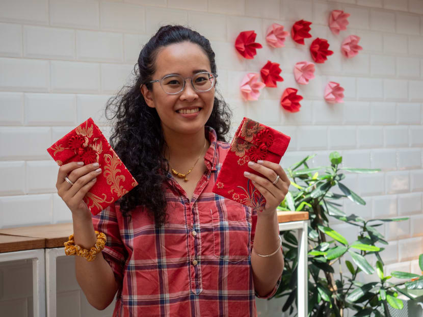 Ms Melissa Lam holding a pair of reusable cloth hongbao. Ms Melissa Lam holding a pair of reusable cloth hongbao.