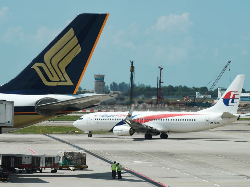 Malaysia Airlines and Singapore Airlines planes are pictured at Changi Airport in Singapore in July 2019.