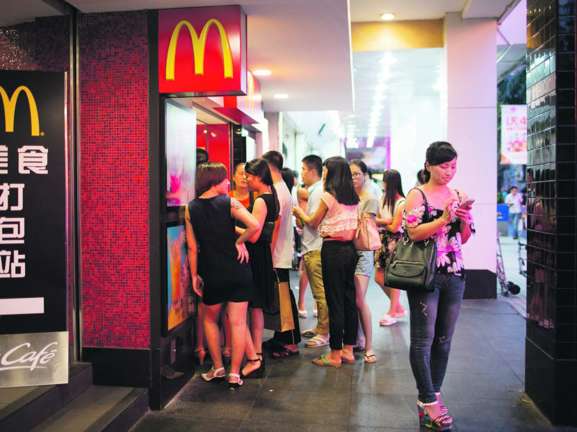 Customers wait in line at a McDonald's Corp. restaurant in the pedestrianized Dongmen area of Shenzhen, China. Photo: Bloomberg