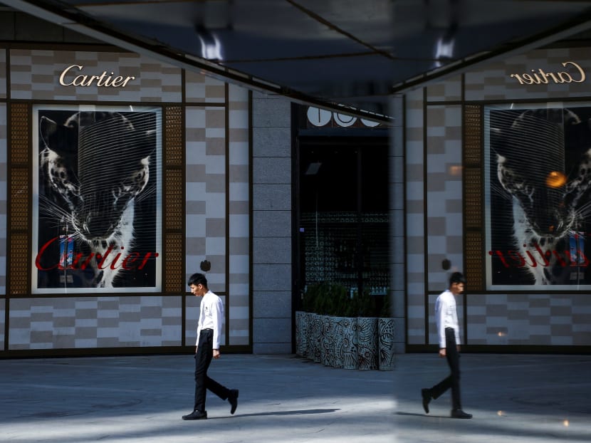 A man walks past a store of the luxury jeweller Cartier in Beijing, China. The net worth of the 153 "super rich" members of China’s Parliament and its advisory body amounts to US$650 billion, according to the Hurun Report, a research organisation in Shanghai that tracks the wealthy in China. Photo: Reuters