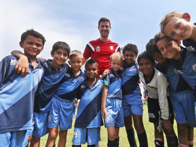 Fulham’s academy player recruitment manager Dan Rice with youngsters from the JSSL Elite Academy. Photo: Ooi Boon Keong