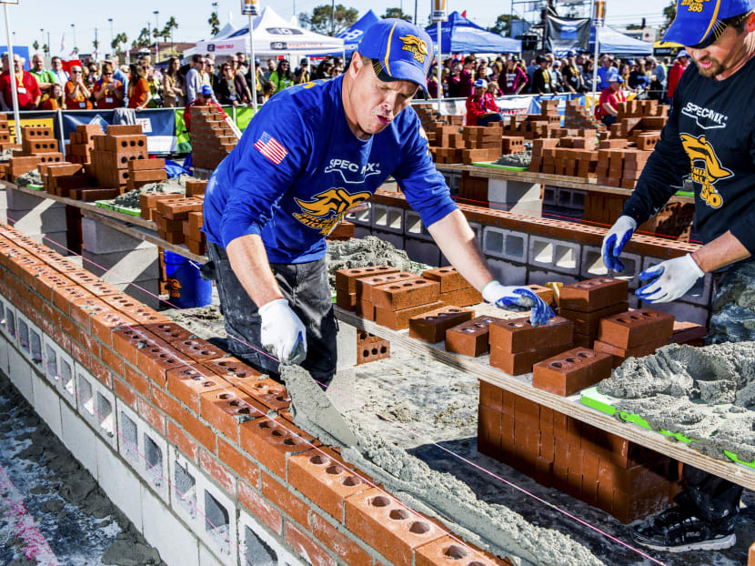 Two-person teams compete in the Bricklayer 500 championship outside the Las Vegas Convention Center in Nevada. Here at the Bricklayer 500, humans are holding off the future with trowel and muscle. But that may not last. Bricklayers are becoming increasingly harder to find nationwide. Photo: The New York Times