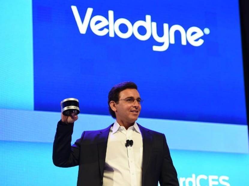 Ford CEO Mark Fields shows off the new Velodyne Puck sensor at a press conference on CES Press Day, January 5, 2016 in Las Vegas, Nevada ahead of the CES 2016 Consumer Electronics Show. Photo: AFP