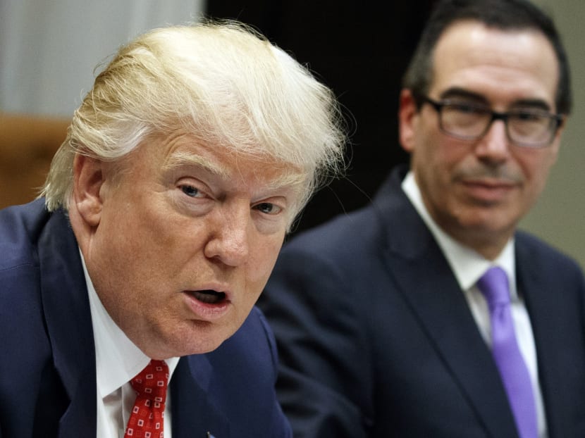 Treasury Secretary Steven Mnuchin listens at right as President Donald Trump speaks during a meeting on the Federal budget, Wednesday, Feb. 22, 2017, in the Roosevelt Room of the White House in Washington. Photo: AP