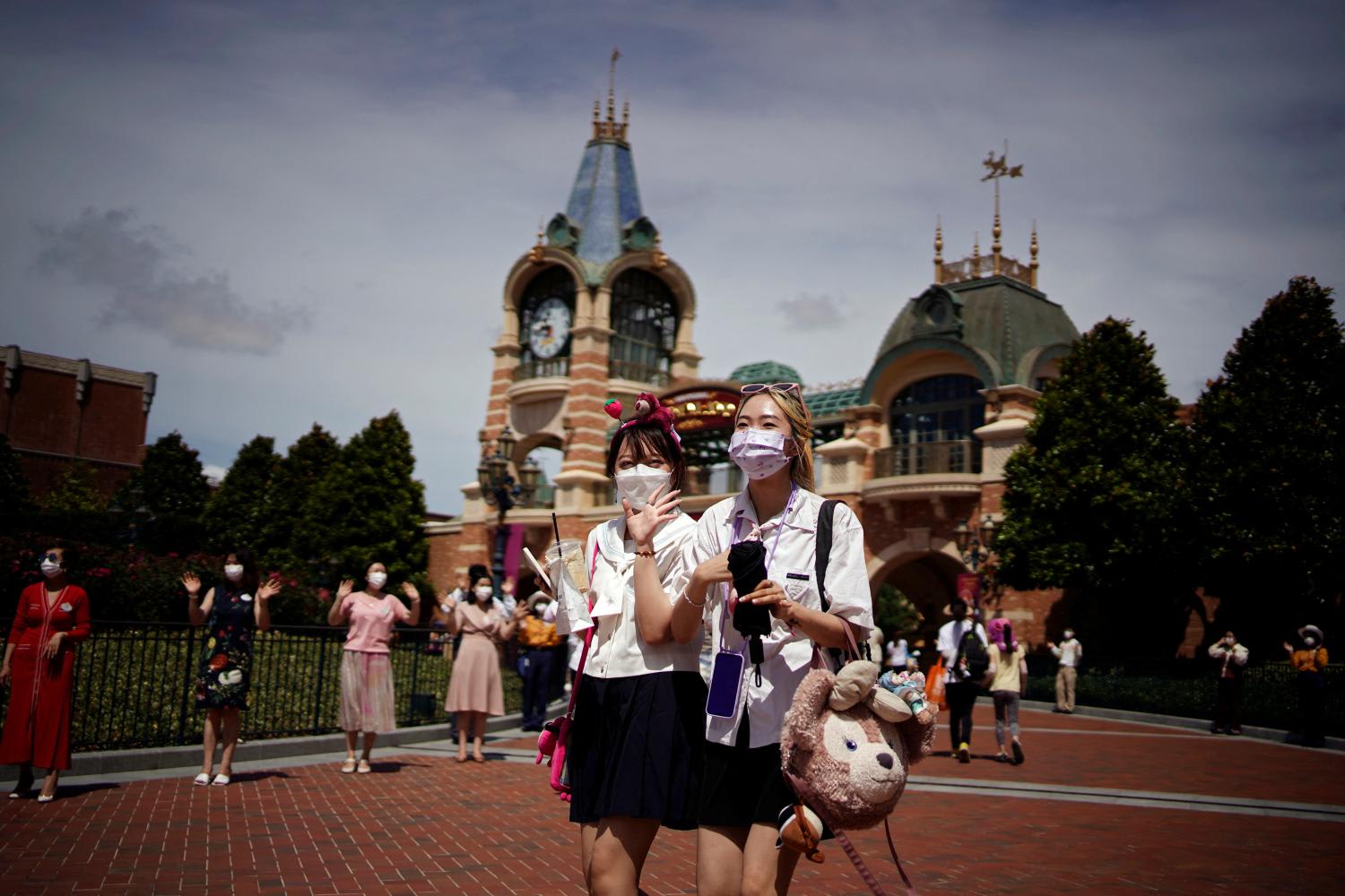 People wearing face masks visit the Shanghai Disney Resort, as the Shanghai Disneyland theme park reopens after being shut for the Covid-19 outbreak, on June 30, 2022.