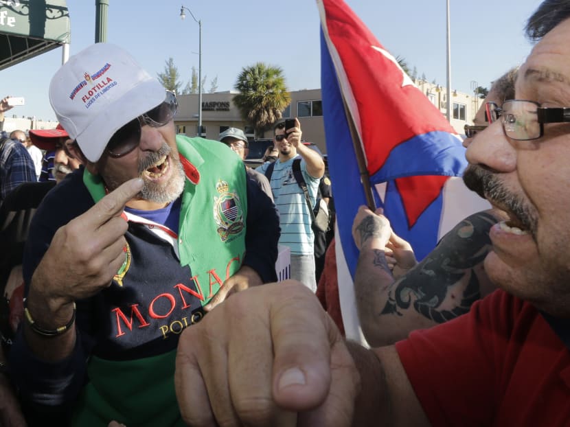 Anti-Castro protester Lazaro Lozano, left, argues with an unidentified pro-Obama supporter in the Little Havana area of Miami, Wednesday, Dec. 17, 2014. Lozano expresses his disagreement with a surprise move announced by senior Obama administration officials that could pave the way for a major shift in U.S. policy toward the communist island nation. Photo: AP