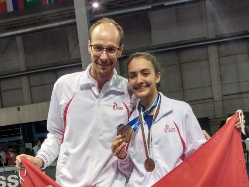 Amita Berthier (right) with her coach Ralf Bissdorf at the World Cadet & Junior Championships. Photo: Fencing Singapore