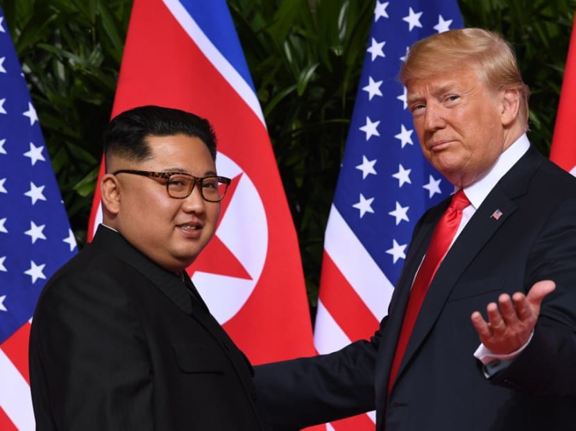 US President Donald Trump gestures as he meets with North Korea's leader Kim Jong Un at the start of their historic US-North Korea summit, at the Capella Hotel on Sentosa island in Singapore, June 11, 2018.
