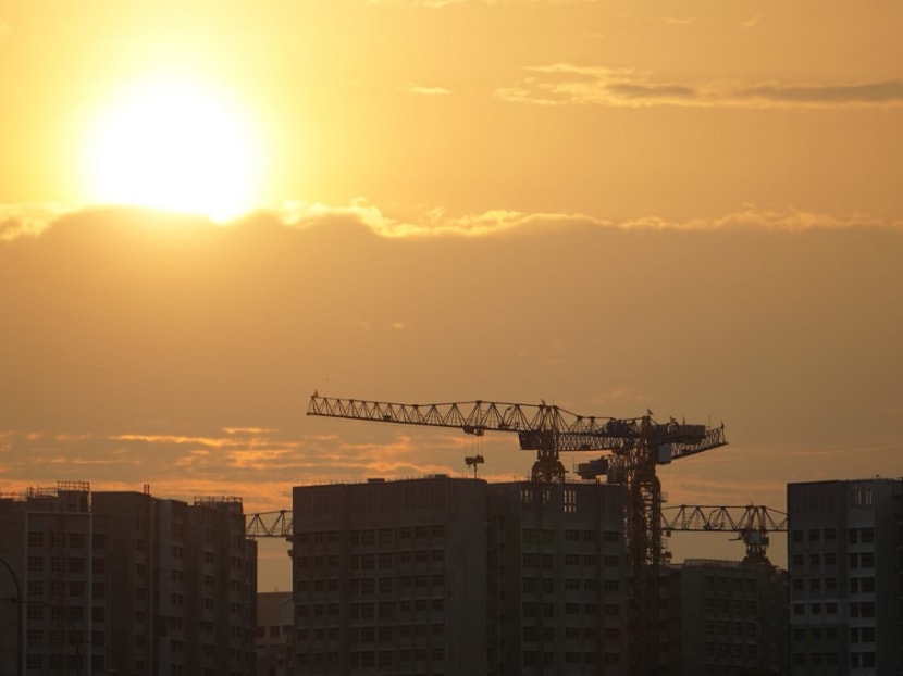 The sun sets behind under-construction residential buildings in Singapore on June 11, 2021.