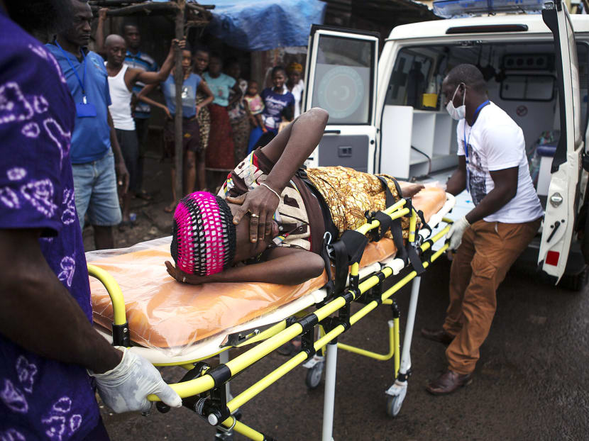 A pregnant woman suspected to have contracted Ebola is lifted into an ambulance in Sierra Leone. The number of people in the country contracting Ebola is doubling every 25 to 30 days. Photo: REUTERS