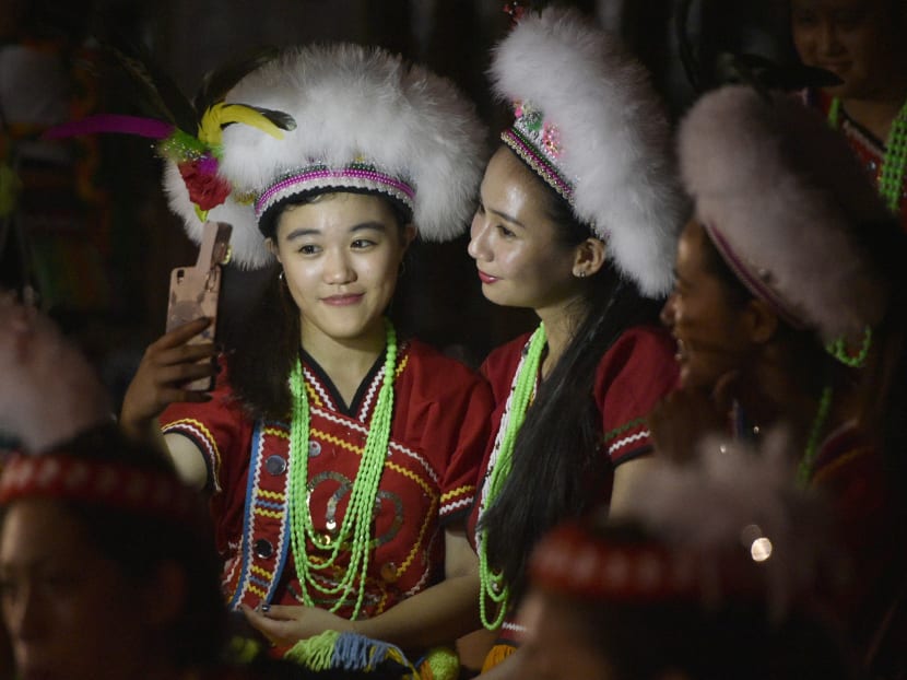 This picture taken on Aug 19, 2017, shows members of the Amis indigenous group posing for a selfie during the traditional harvest festival in Hualien, eastern Taiwan. Photo: AFP