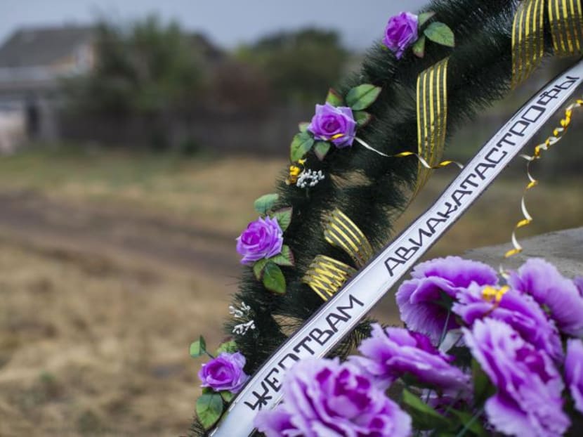 A wreath with an inscription reading "To the victims of the air crash" is pictured at the site where the downed Malaysia Airlines flight MH17 crashed, near the village of Hrabove (Grabovo) in Donetsk region, eastern Ukraine Sept 9, 2014. Malaysia Airlines flight MH17 broke apart over Ukraine due to impact from a large number of fragments, the Dutch Safety Board said Sept 9, in a report that Malaysia's prime minister and several experts said suggested it was shot down from the ground. Photo: Reuters