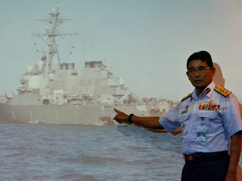Malaysian Maritime Director Indera Abu Bakar officer points to a hole in the USS John McCain to show the media in Putrajaya, Malaysia. Photo: Reuters